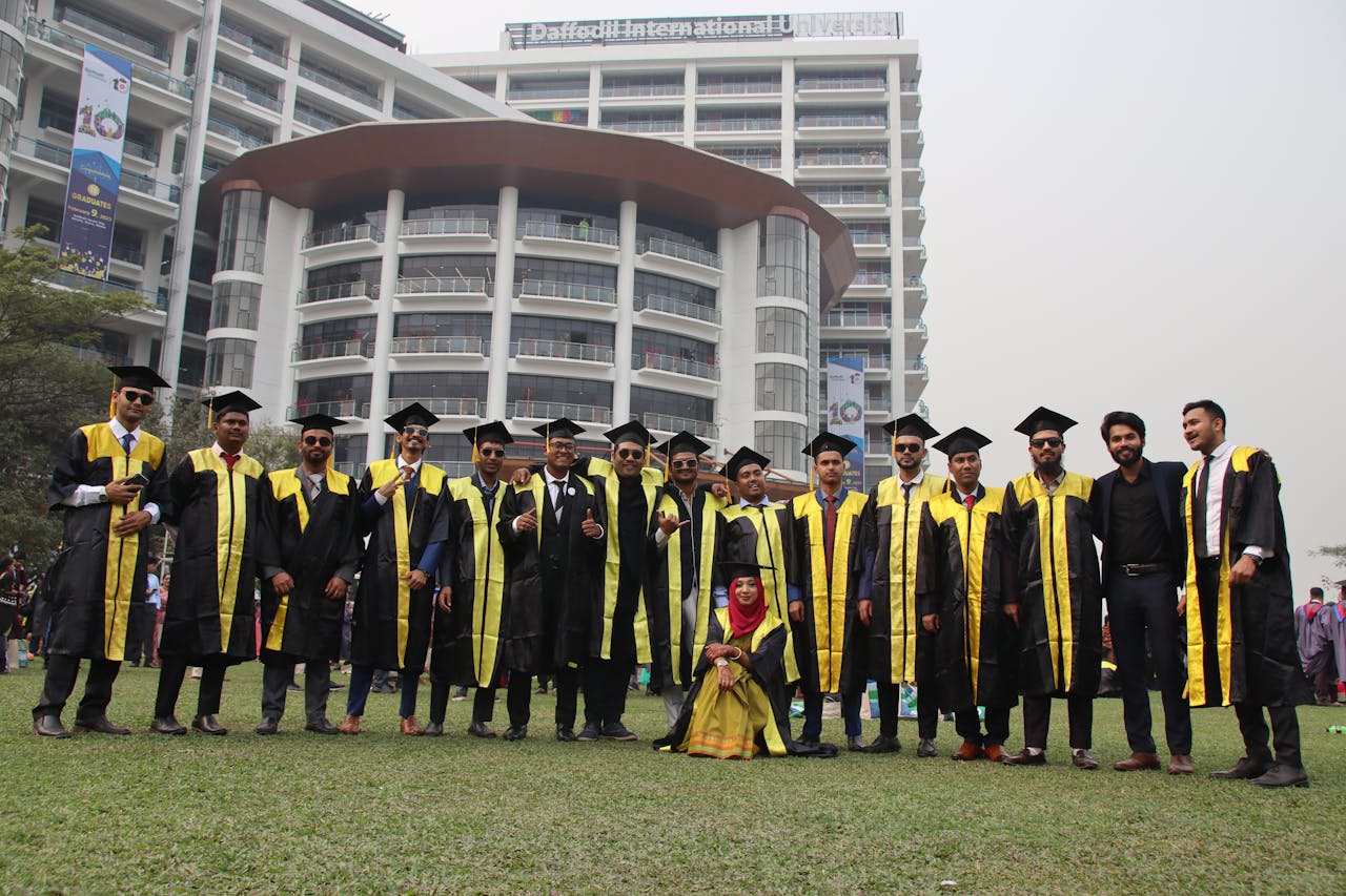 Graduates in caps and gowns gather for a photo at Daffodil International University.